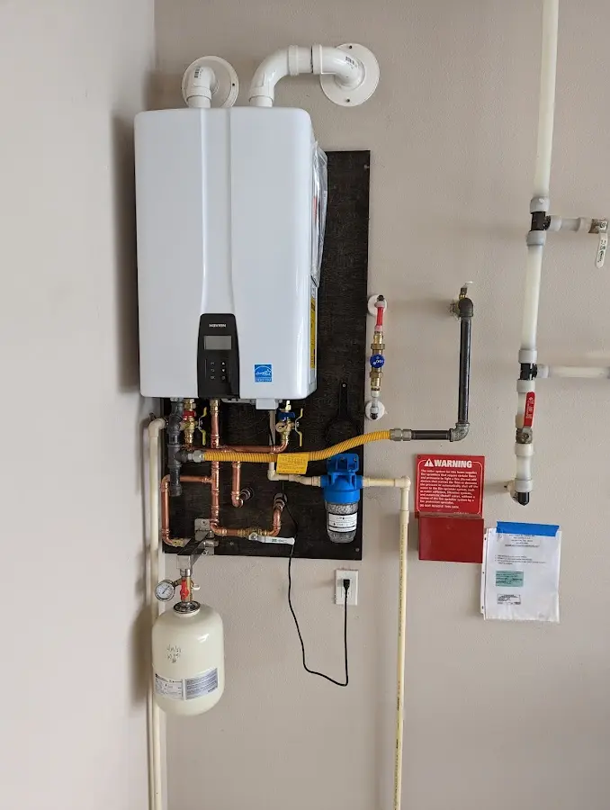 Professional plumber installing copper piping in a Newnan home